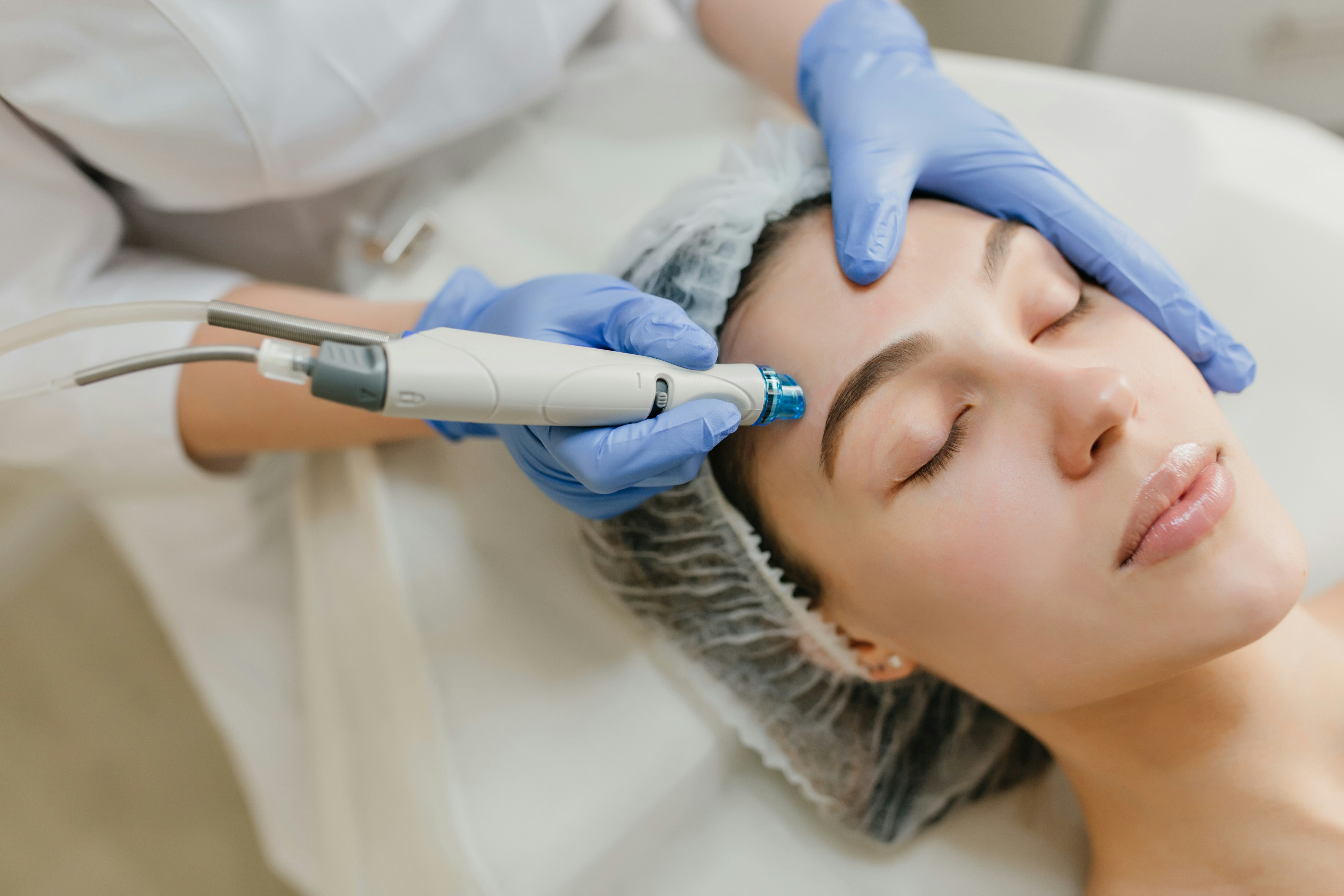 Board-certified aesthetician performing a precision facial treatment at an independent MedSpa, demonstrating the provider expertise that AI search rewards over generic chain clinic listings